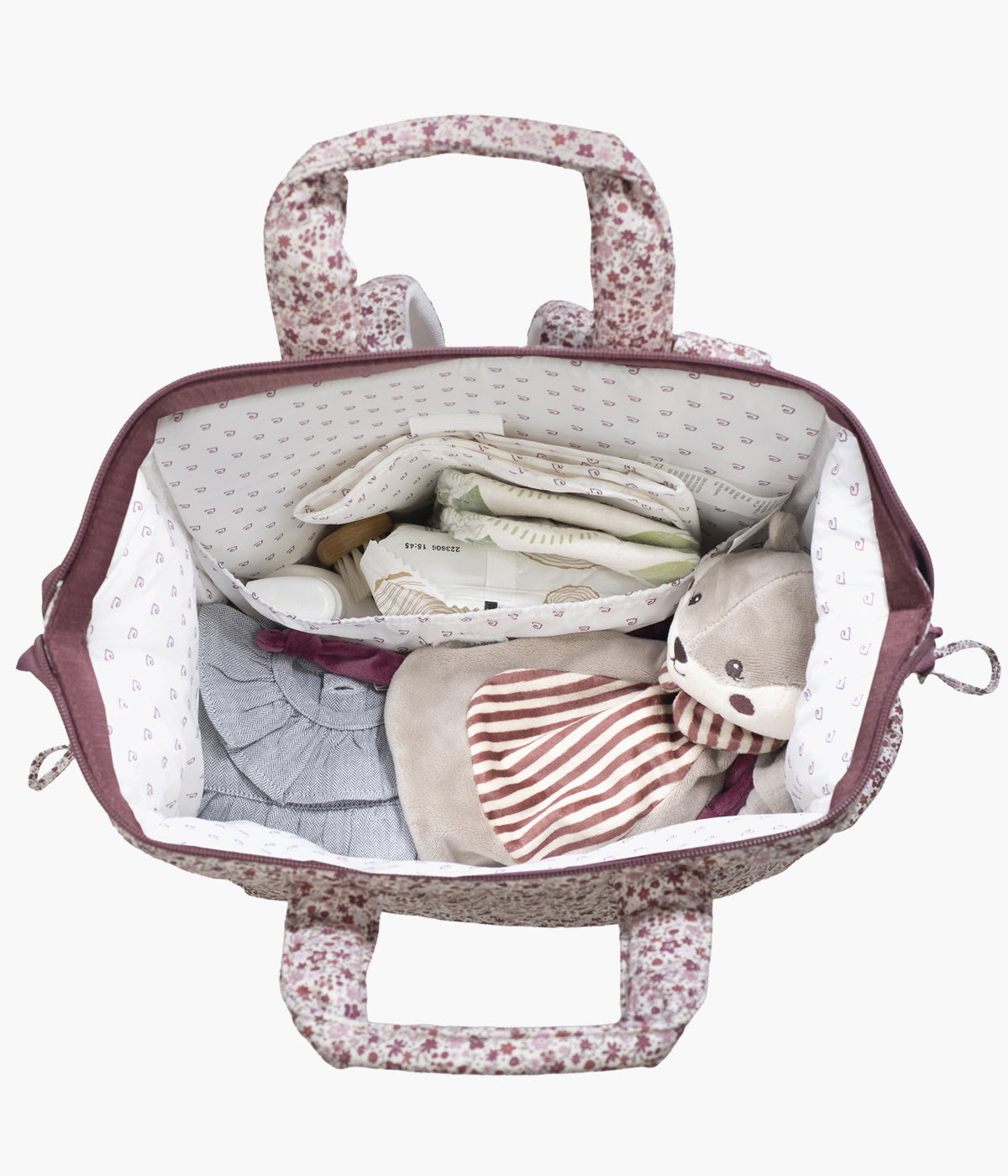 Mochila de maternidade Cherry Flowers da Pasito a Pasito aberta e com coisas de bebé arrumadas.