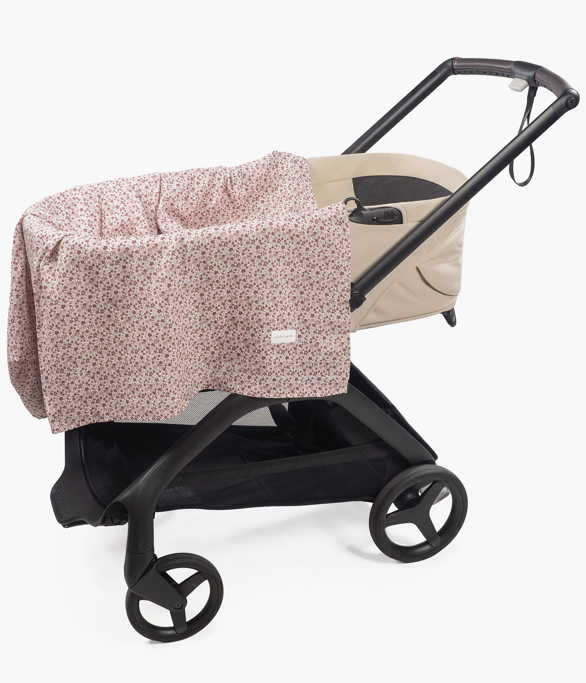 Swaddle musselina em bambu Pasito a Pasito Cherry Flowers em cima de um carrinho de bebé.