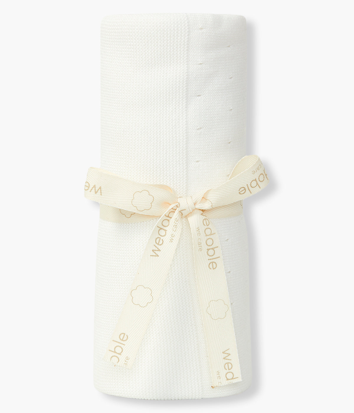 Manta em malha de algodão orgânico pérola da Wedoble para bebé e recém-nascido(a). Delicada manta de formato retangular com detalhes perfurados.