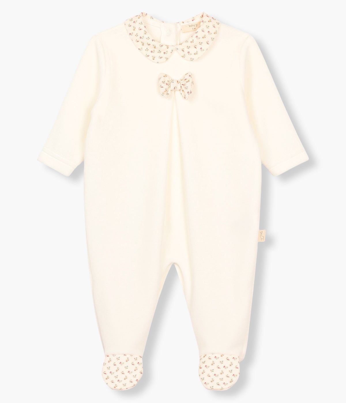 Vista frontal do babygrow em veludo pérola da Baby Gi para bebé menina e recém-nascida. Gola redonda cortada, laço e pés com padrão floral. Abertura nas costas e entrepernas.