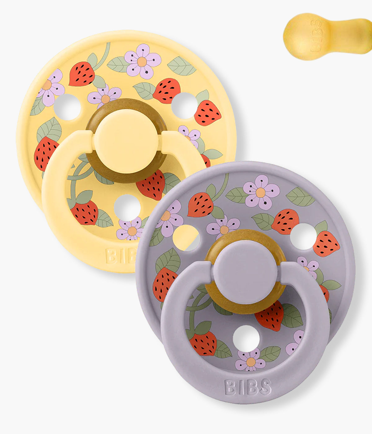 Pack de 2 chupetas Bibs x Liberty Colour Strawberries and Cream Pale Butter Mix com tetina redonda em borracha 100% natural. Conjunto composto por 1 chupeta amarela e 1 chupeta lilás com padrão morangos e flores.