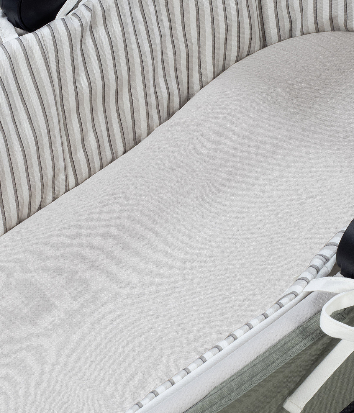 Forra para alcofa Walking Mum Botton Strips branco com padrão riscas cinza-claro e cinza-escuro, 100% algodão. Desenhado para proporcionar ao bebé o máximo conforto e elegância, este conjunto é composto por uma forra com varas e um lençol tecido musselina ajustável de toque suave e respirável, ideal para a pele delicada do recém-nascido.