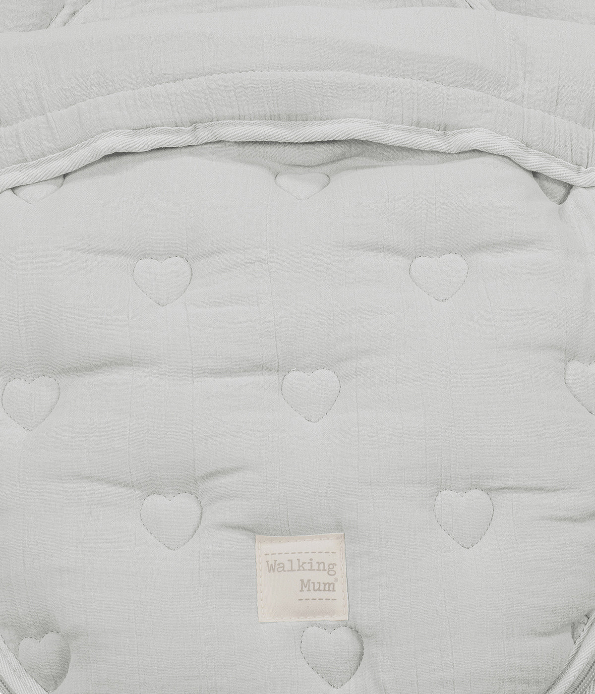 Vista aproximada dos corações bordados do saco de dormir 2 em 1 Walking Mum Sintra verde.