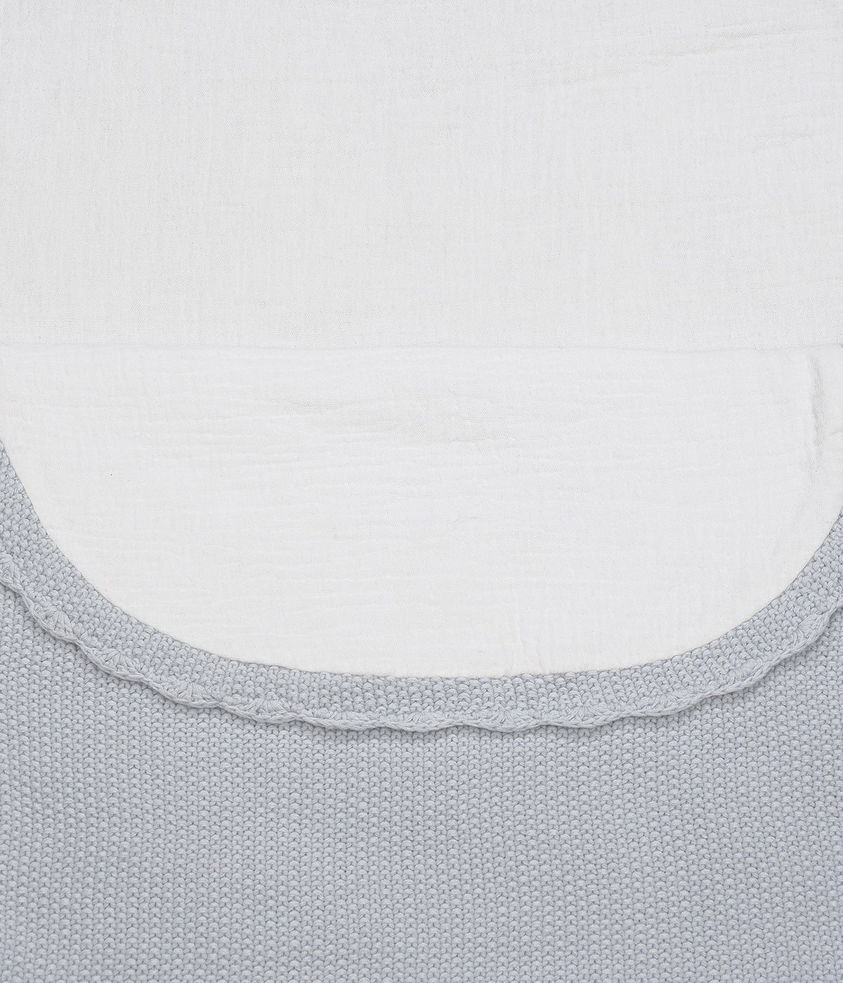 Saco manta em malha de algodão tricot azul da Pasito a Pasito para bebé menino. Este suave saco manta destaca-se pelo seu ponto de arroz requintado e um elegante acabamento com rebordo ondulado. Possui um design funcional com um interior em tecido musselina branco, permitindo ser utilizado como ninho ou como manta de berço, acompanhando o crescimento e as diferentes necessidades do bebé.