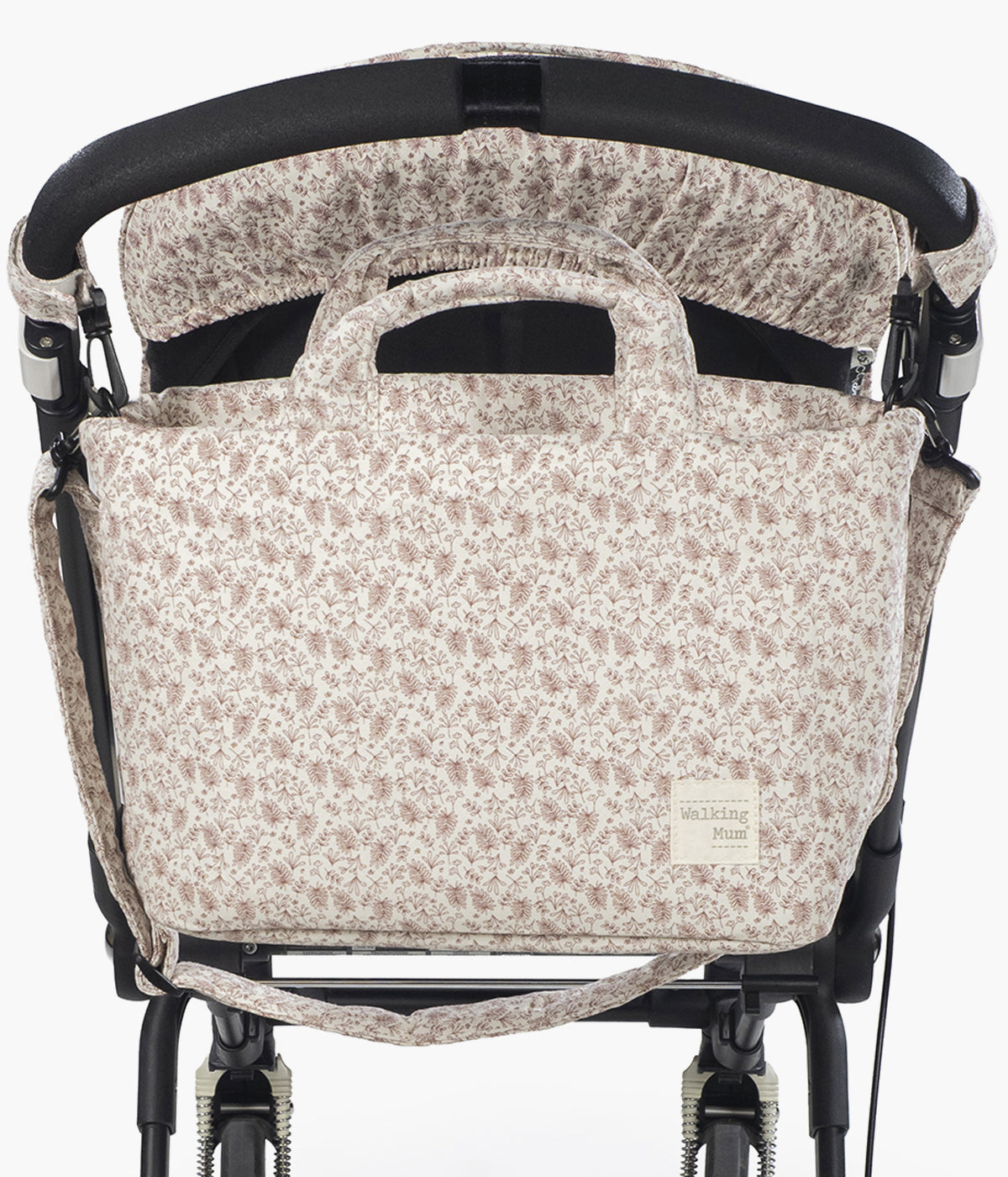 Bolsa de passeio Gala Cerise da Walking Mum pendurada no carrinho.