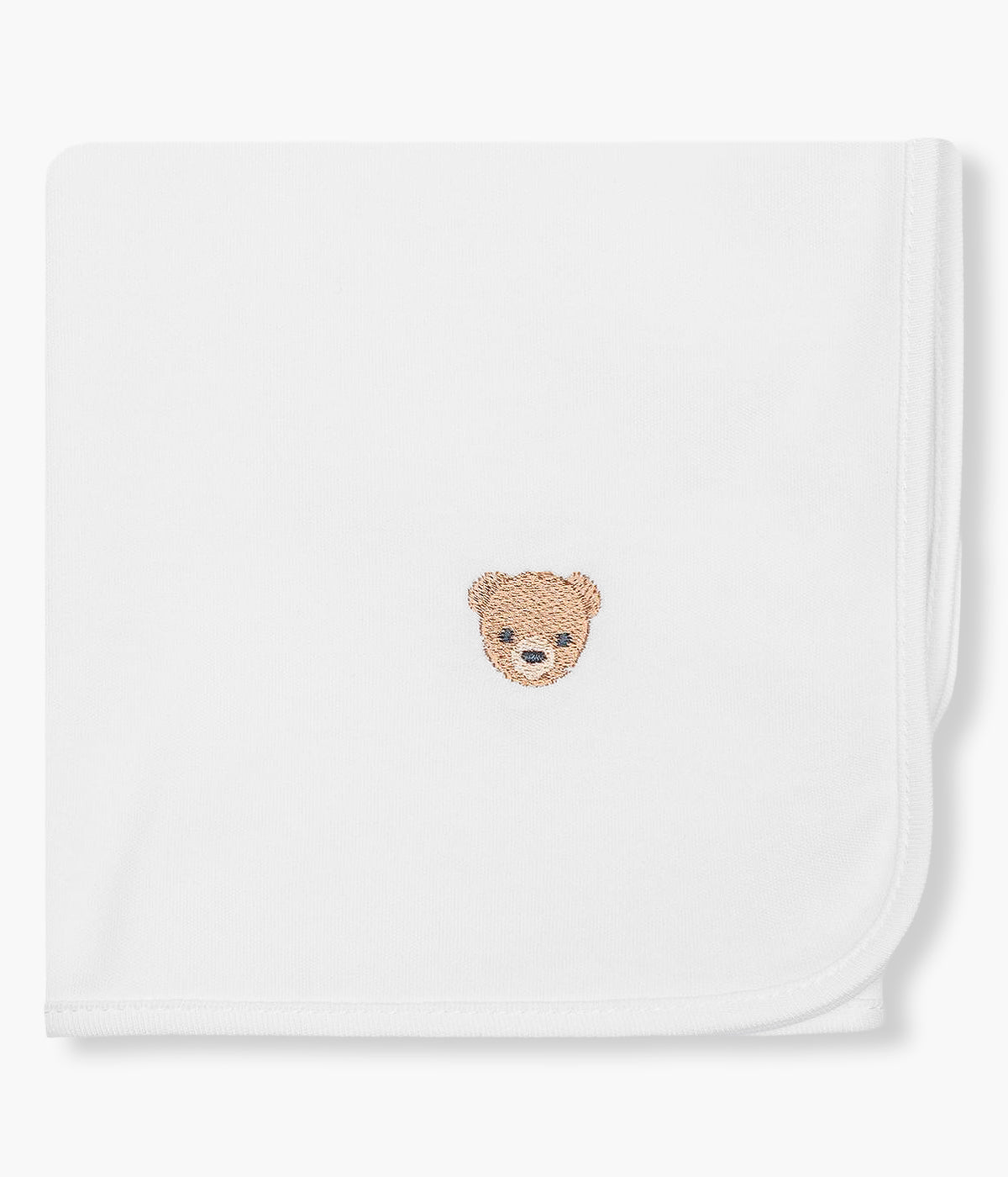 Vista de frente da fralda branca da Baby Gi para bebé e recém-nascido(a), 100% algodão. Detalhe no canto com urso rendado em castanho.