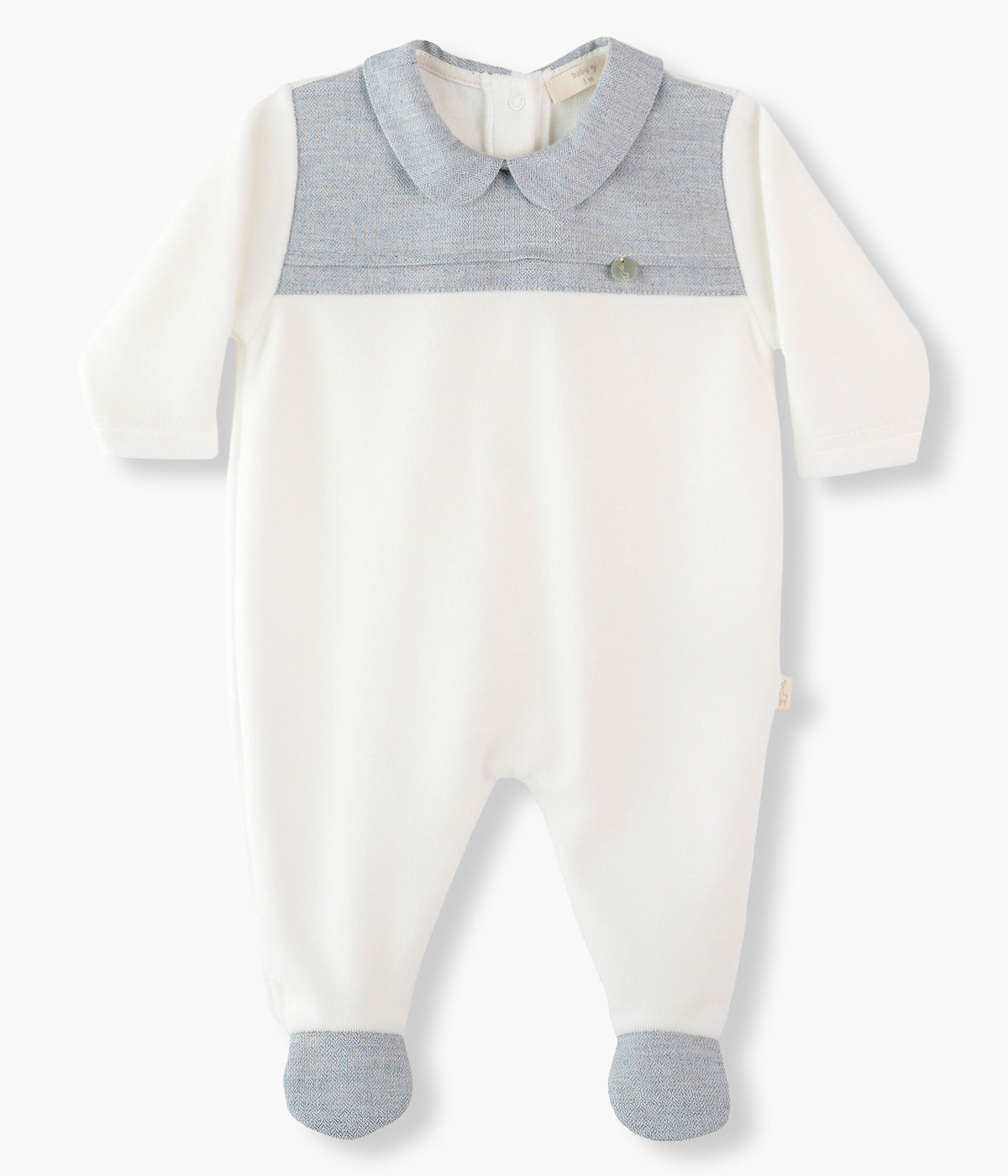 Babygrow em veludo pérola da Baby Gi para bebé menino e recém-nascido. Gola redonda cortada, peito e pés com detalhe me tecido azul-ganga. Medalha madrepérola com logo da marca no peito. Abertura nas costas e entrepernas.