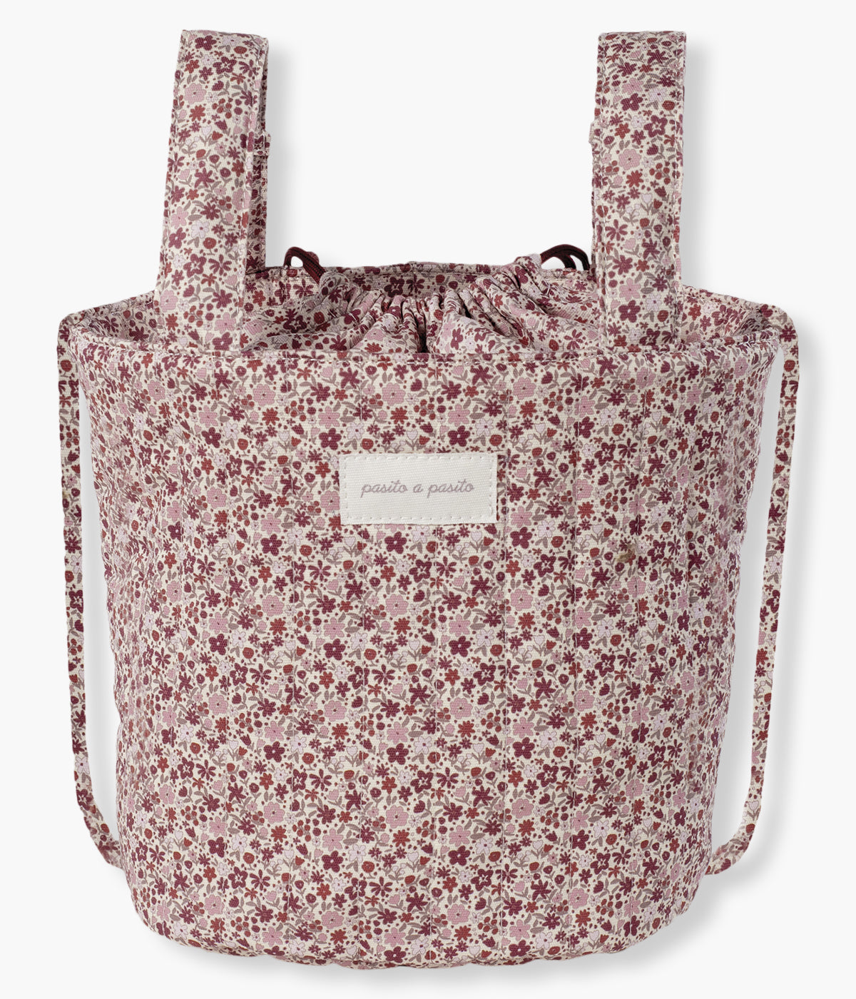 Bolsa Bucket Pasito a Pasito Cherry Flowers com exterior em algodão impermeável com um elegante padrão floral em tons de rosa. O seu formato tipo balde maximiza o espaço interior, permitindo uma organização prática e um acesso rápido aos essenciais da bebé.