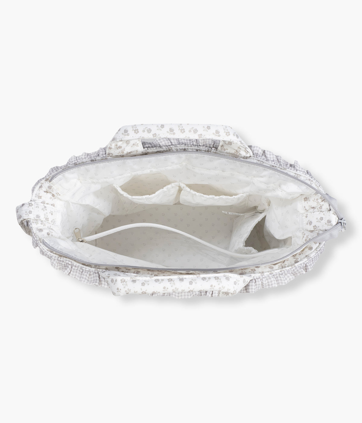 Vista de cima e aberta da mala de Maternidade Little Bloom Flowers da Pasito a Pasito. Prática mala de maternidade que combina elegância com um padrão floral cinza e uma grande capacidade para transportar tudo o que a bebé precisa. Confeccionada em loneta 100% algodão com tratamento resistente à água, esta mala inclui vários compartimentos interiores e um prático resguardo portátil.