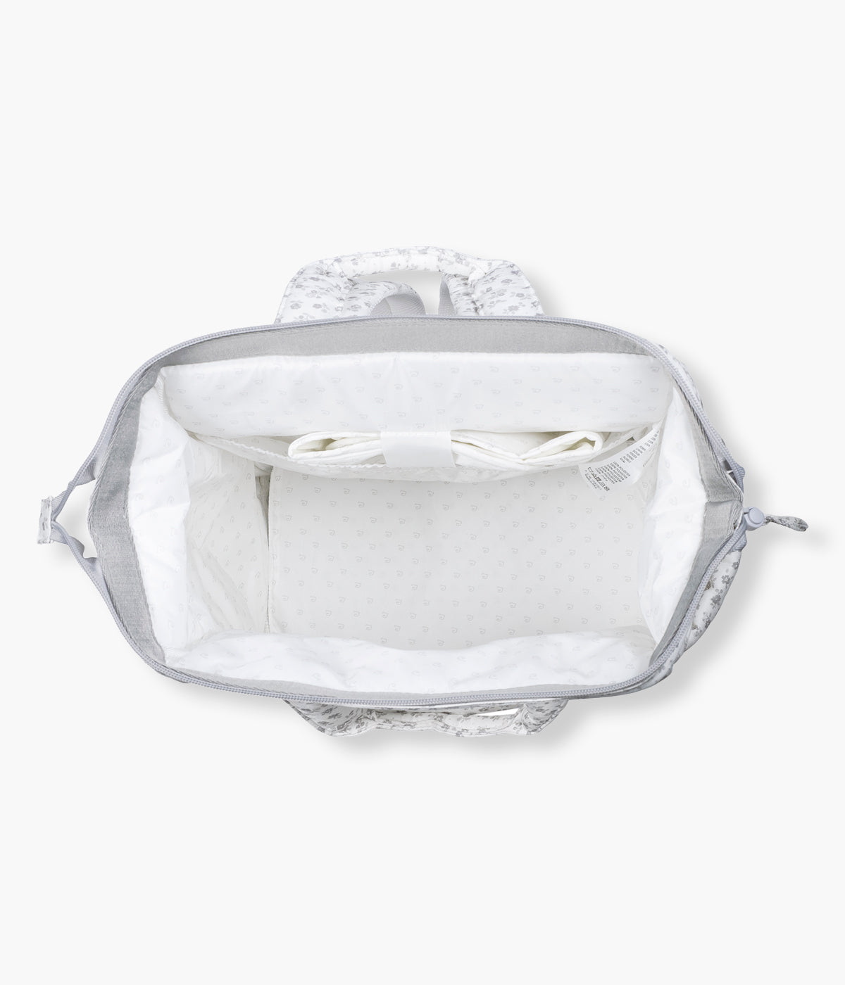 Vista do interior da mochila de maternidade Little Bloom Flowers da Pasito a Pasito. Com exterior em loneta de algodão resistente à água com padrão floral em tons de cinza, esta mochila de maternidade oferece grande capacidade, vários compartimentos e inclui um prático resguardo portátil.