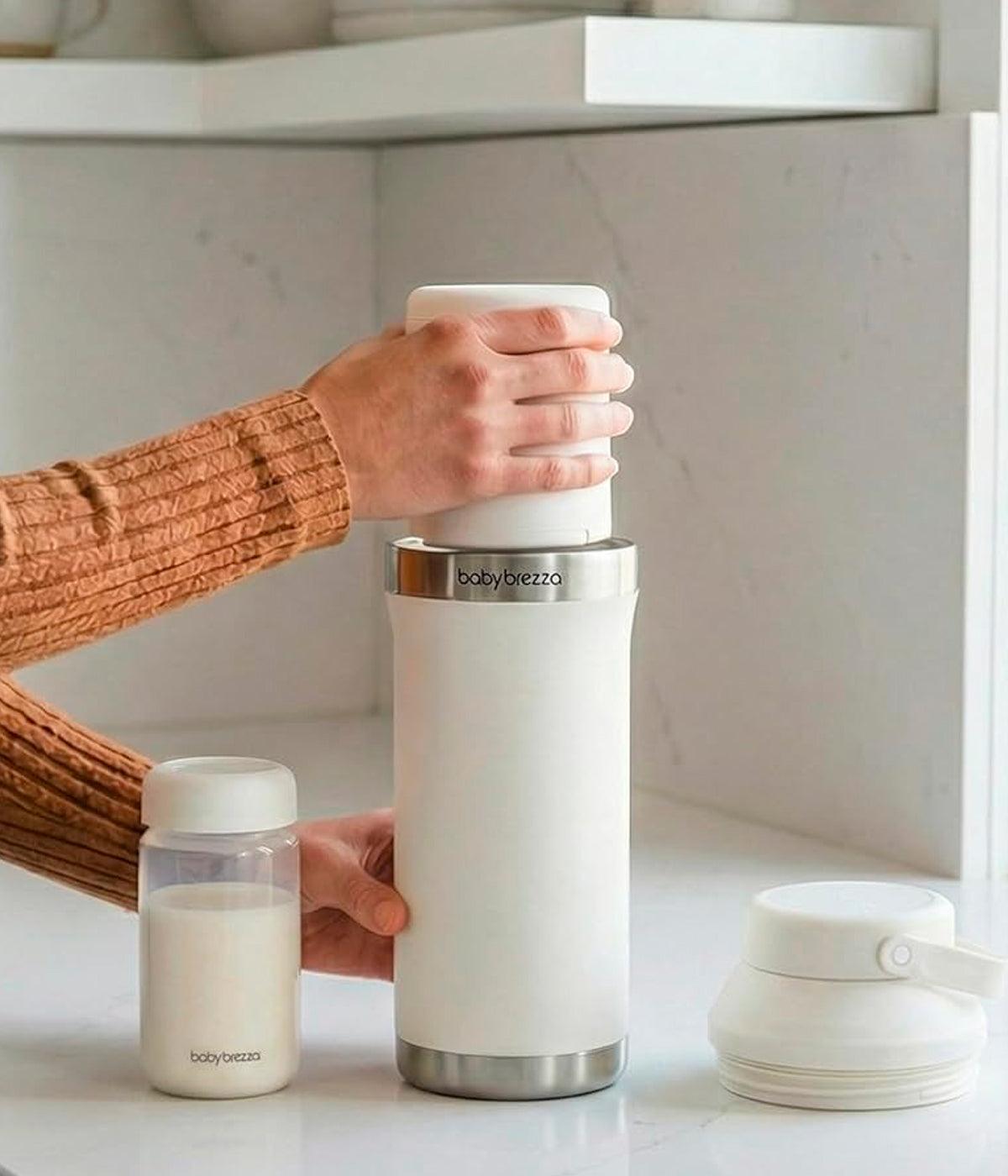 Vista em utilização do refrigerador portátil de leite Materno Baby Brezza All-day Breastmilk Portable Cooler. Prática garrafa térmica com capacidade de 600ml que mantém o leite materno frio até 24 horas, garantindo conservação segura durante todo o dia. Prático, compacto e ideal para mães que extraem leite em casa, no trabalho ou em viagem.