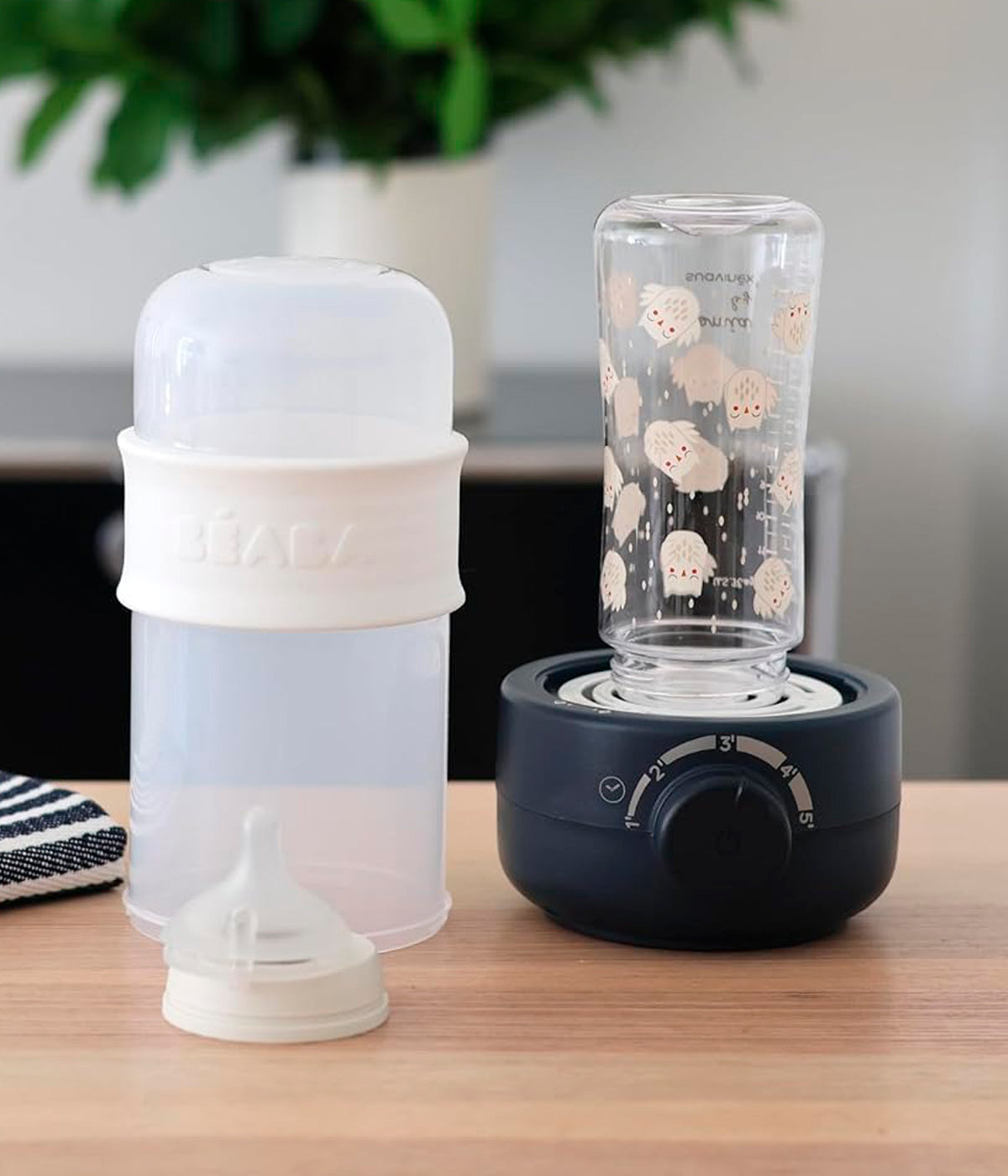 Aquecedor de biberões Babymilk Second da Béaba na cor Night Blue (azul índigo) a esterelizar um biberão.