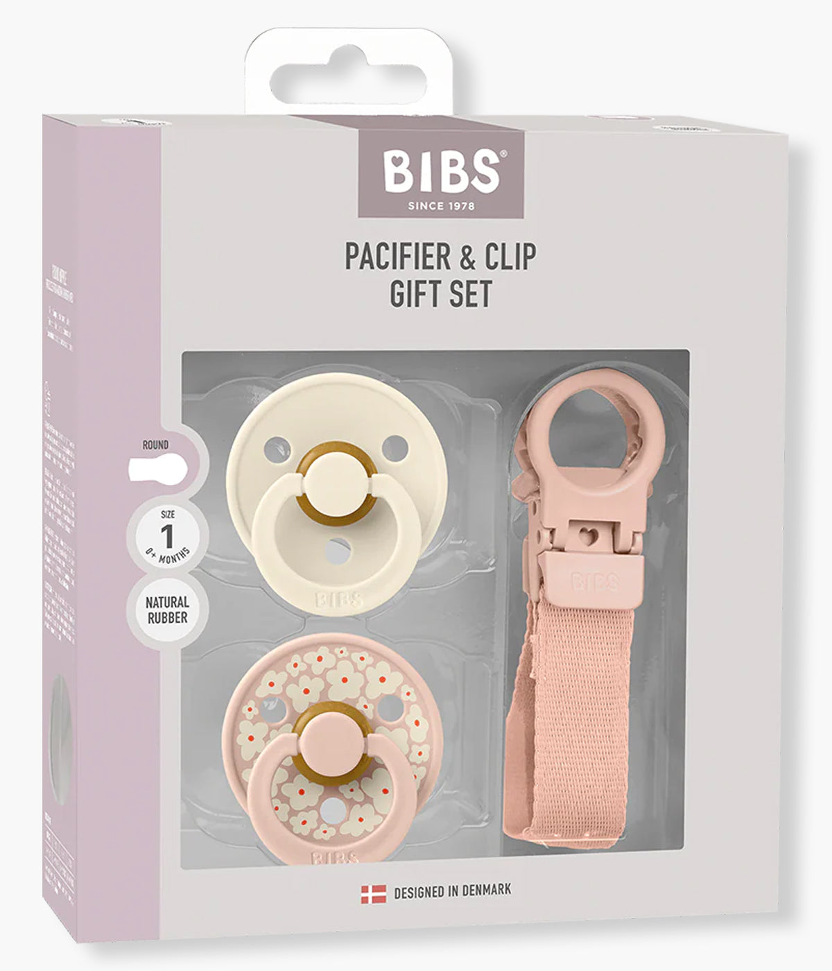 Pack de 2 chupetas Bibs Colour e 1 prende-chupetas Bibs Loop, ambos cor-de-rosa (blush). Pensado especialmente para recém-nascidos, este pack reúne dois essenciais indispensáveis: chupetas com tetina redonda em látex natural e um prende-chupetas funcional que evita quedas e perdas.